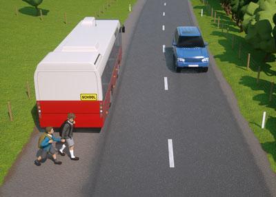Simulated road of a school bus with children behind it about to cross the road where there is an oncoming car.