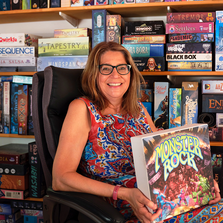 Amanda Milne with Monster Rock, one of the board games she has designed. Photo by Mark Smith.