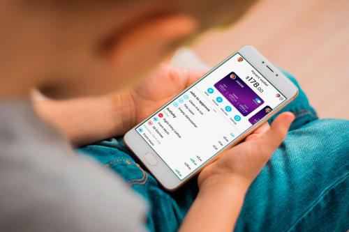 A child holds a smartphone looking at the SquareOne budgeting app.