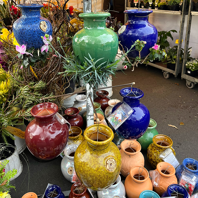 Intriguing upside-down hanging plant pots on sale at Hobart’s weekend Salamanca Markets. 