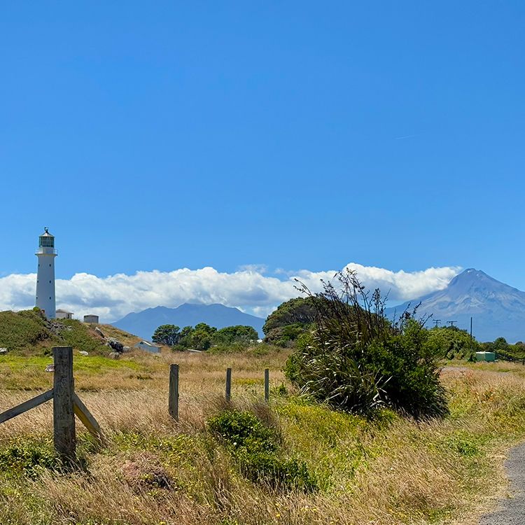 Cape Egmont Lighthouse at Pungarehu and Mount Taranaki.