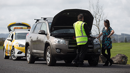 AA Roadservice assisting a broken-down car on the side of the road
