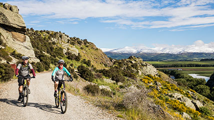 Two people biking on a mountain