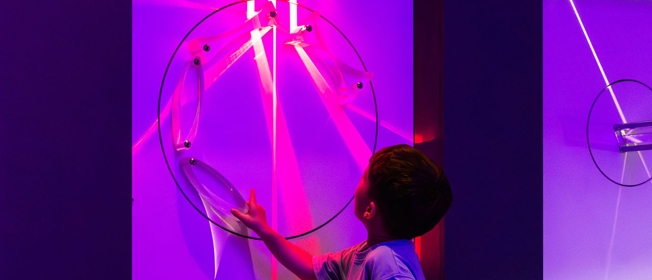 Young girl smiling with colourful light ascending from her head