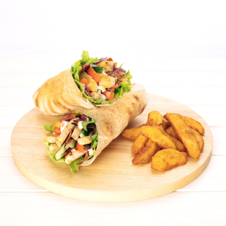 Pita wrap and wedges on a wooden plate