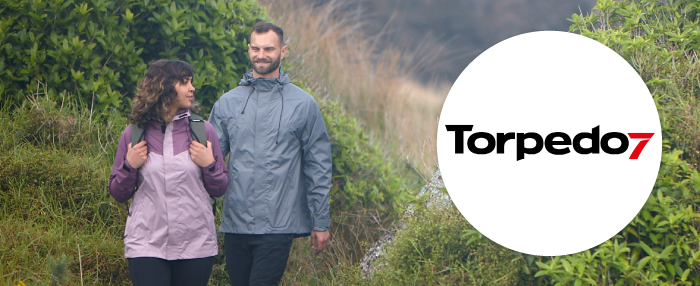 A man and a woman in torpedo7 walking on a hike