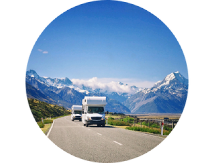 Two vans on the road with mountain ranges background