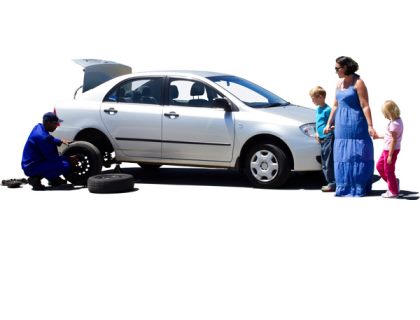 Mother and her two children watching AA Roadservice employee change their tyre