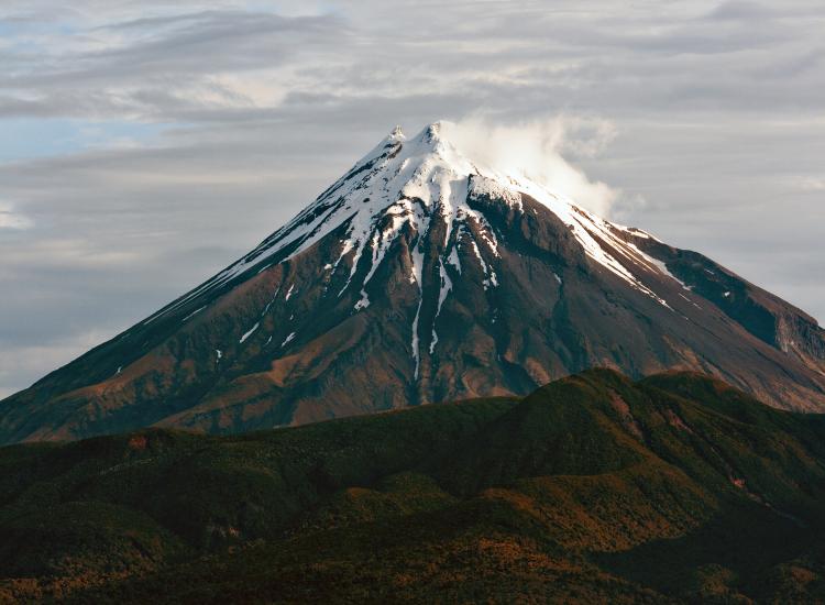 Mount Taranaki photographed late in the evening from near the sea cliffs at Tapu