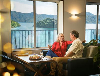 An older couple sitting together on the ferry lounge