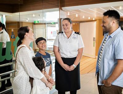 An Interislander crew member talking to a family on board
