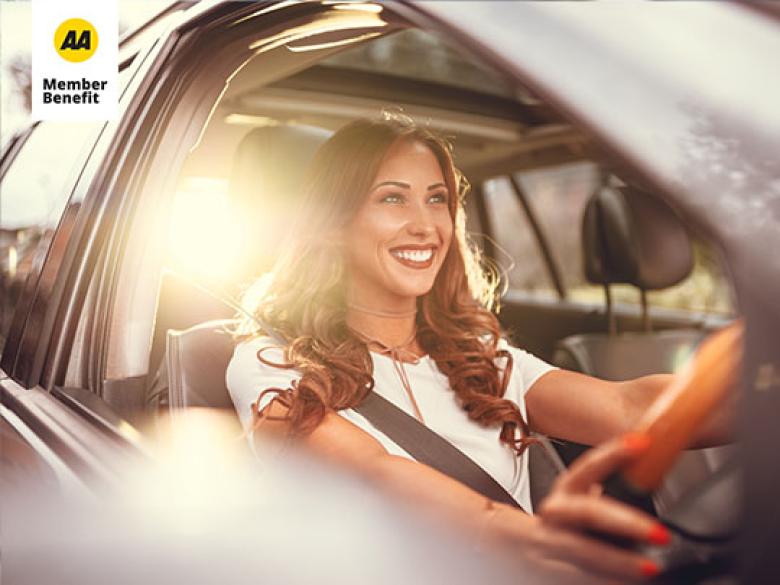 Woman smiling in the driver seat of a car