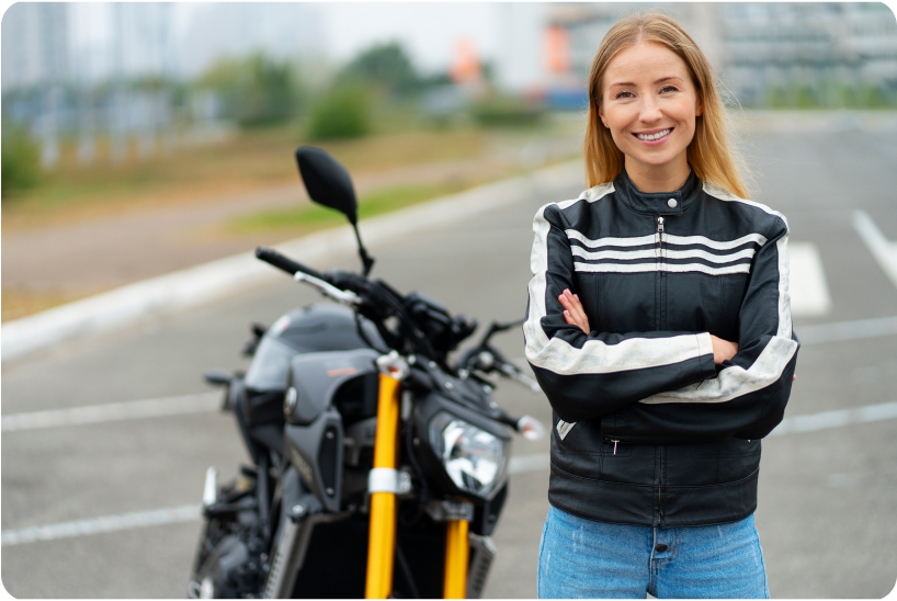 a woman standing next to a parked motorcycle.