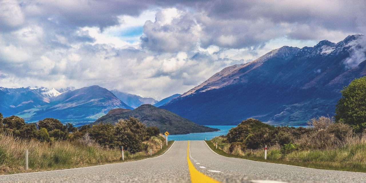 Country road heading towards mountain views