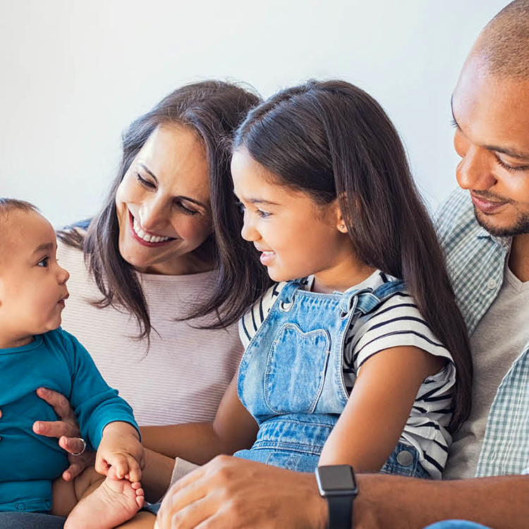 Young family of a mum, dad, child daughter, and a baby