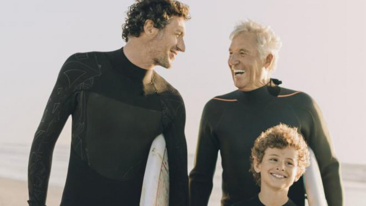 A grandfather, son, and grandson photo at the beach