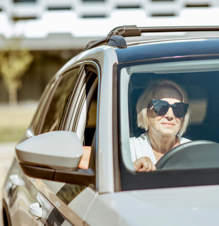 Old lady behind wheel.