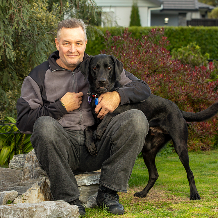Stevin Creeggan with his service dog, Loki. Photo by Tim Cuff.
