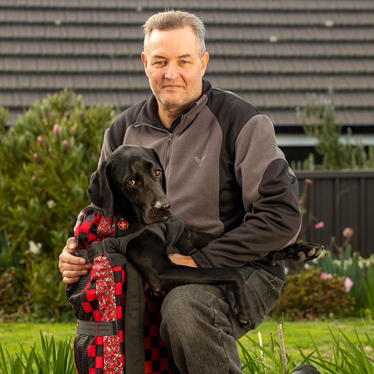Stevin with Loki in his custom-made motorbiking backpack. Photo by Tim Cuff.