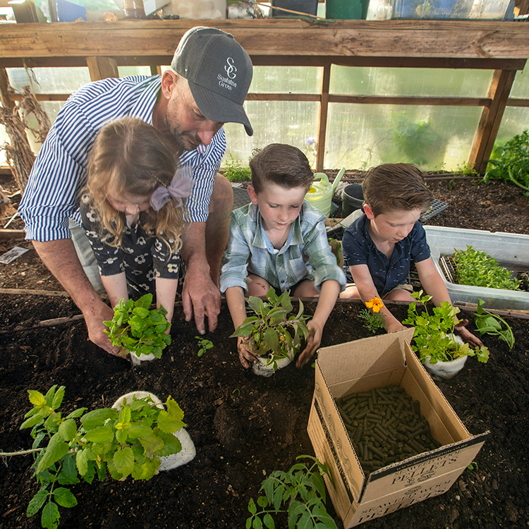 The Hammond family get hands on with planting. Photo by Tim Cuff.