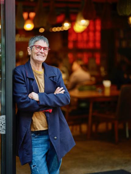 Restaurateur, Yael Shochat stands in the doorway of Ima Cuisine, Auckland
