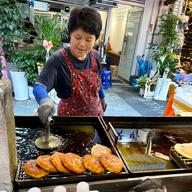 In the massive Namdaemun market in Seoul, pancakes with spicy filling are served hot off the grill.