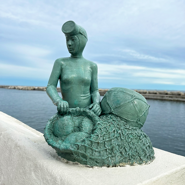 A sculpture on a seawall on Jeju Island, honours the local Haenyeo women divers.