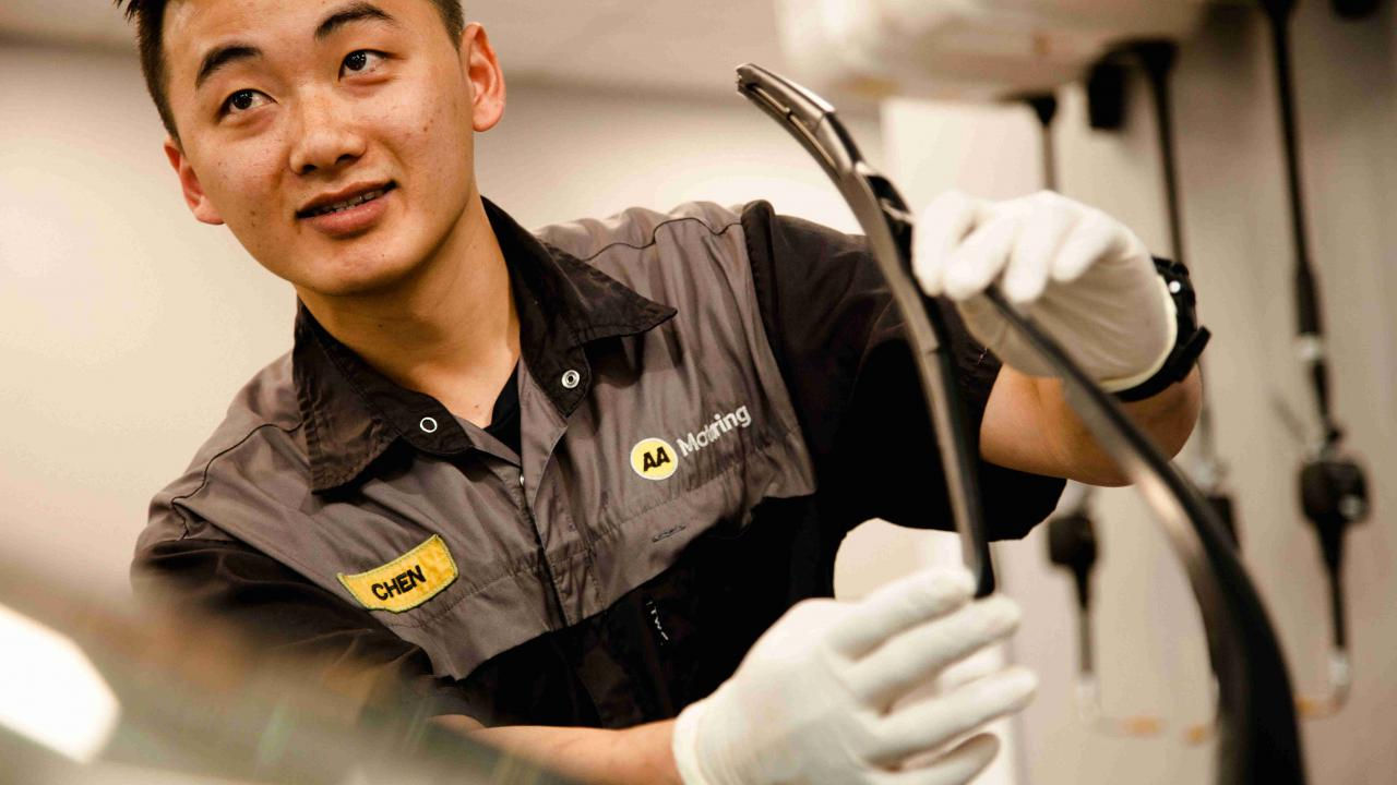 AA technician inspecting car wiper during a pre purchase vehicle inspection