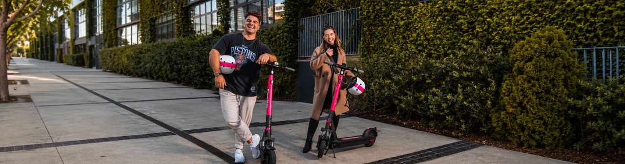 Two people on Flamingo scooters