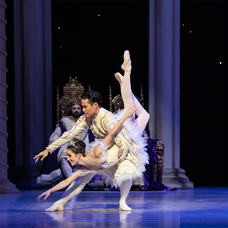 Man and woman ballet dancers posed on stage