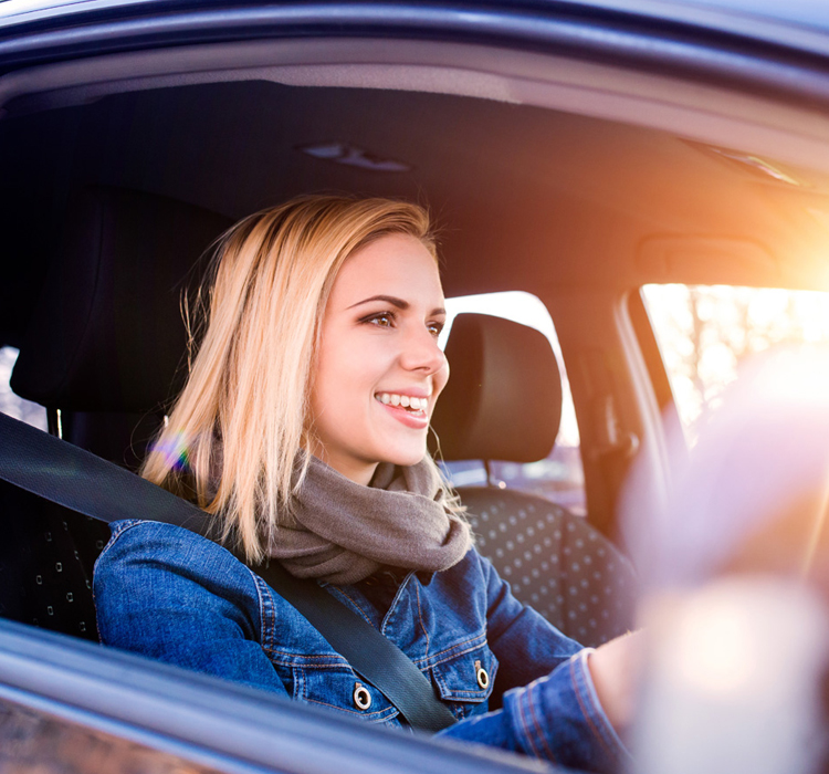 Young woman behind the steering wheel